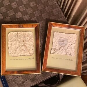 Two cast paper art pieces by Mick Mather.